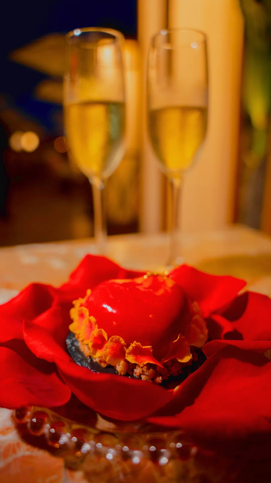 Decoración romántica para aniversario en Viva La Vida con pétalos de rosa y velas
